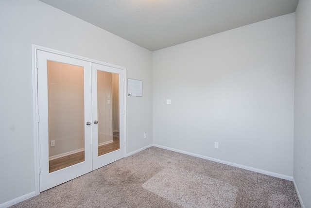 unfurnished bedroom with french doors, a closet, and carpet flooring