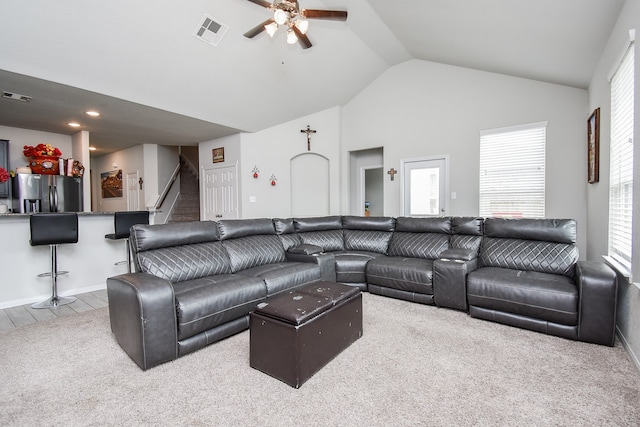 carpeted living room featuring ceiling fan and high vaulted ceiling