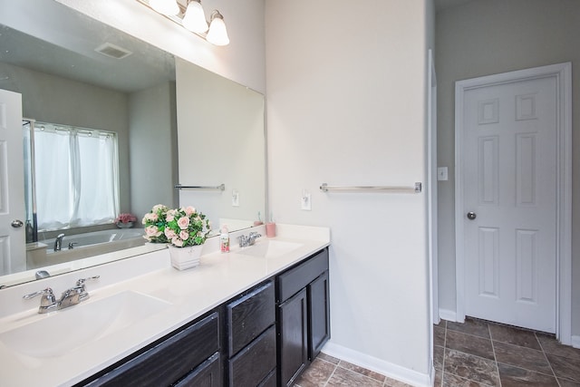 bathroom featuring vanity and a bath