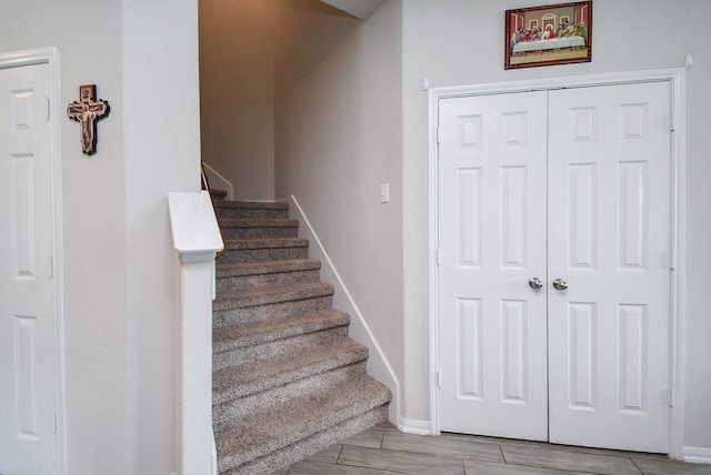 stairs with hardwood / wood-style flooring