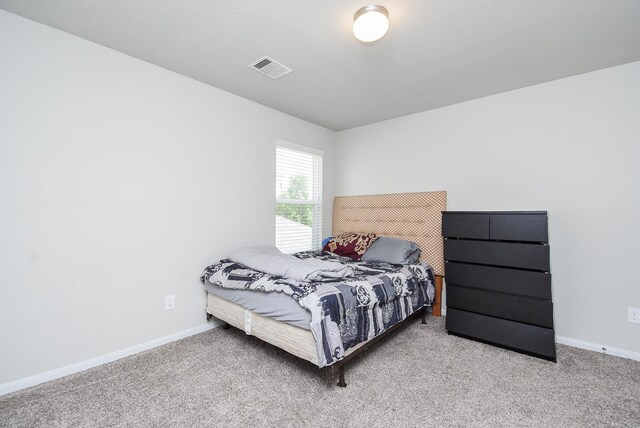 bedroom with carpet flooring, visible vents, and baseboards