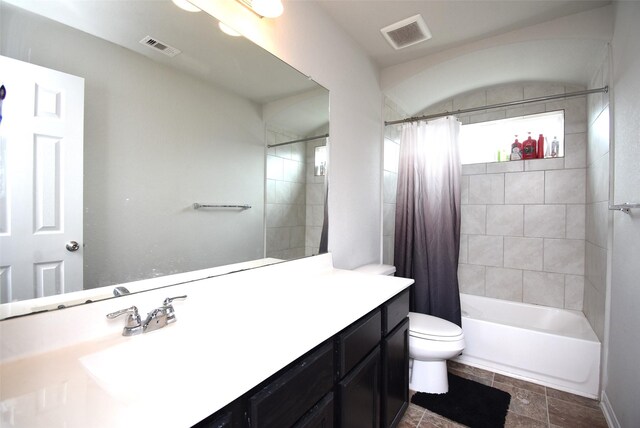 full bath featuring vanity, toilet, visible vents, and shower / tub combo with curtain