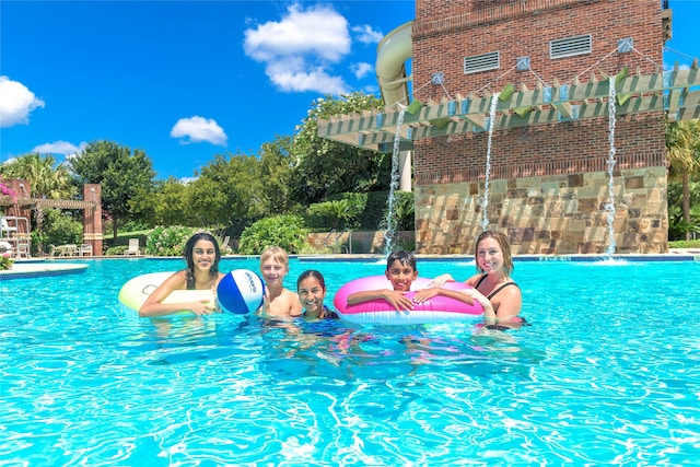 view of swimming pool with a pergola and pool water feature