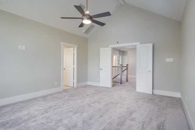 unfurnished bedroom with ceiling fan, high vaulted ceiling, and light colored carpet