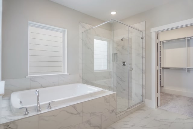 bathroom featuring separate shower and tub and a wealth of natural light