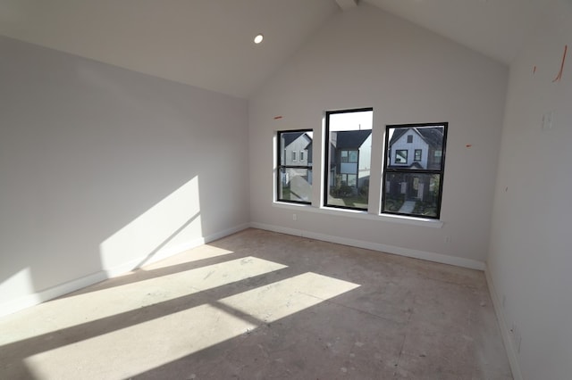 unfurnished room featuring high vaulted ceiling