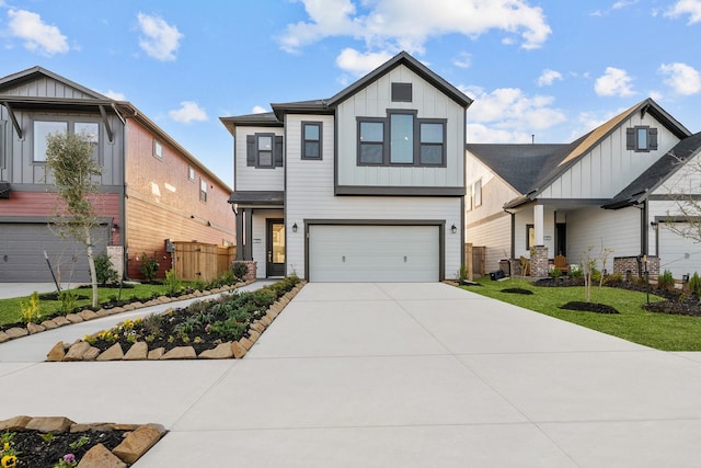 view of front facade featuring concrete driveway, an attached garage, fence, a front lawn, and board and batten siding