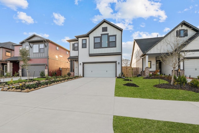 view of front of house featuring a garage, driveway, fence, board and batten siding, and a front yard