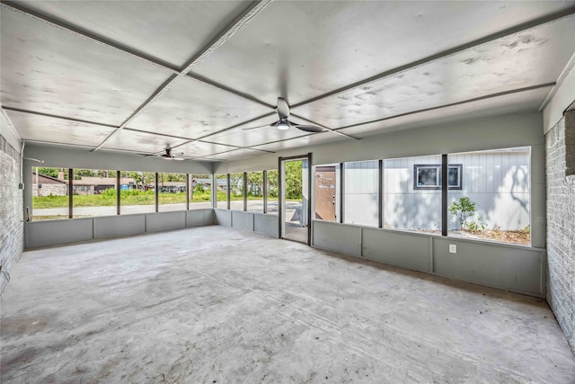 unfurnished sunroom with ceiling fan