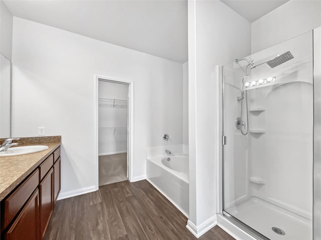 bathroom with vanity, hardwood / wood-style floors, and separate shower and tub