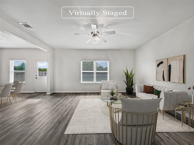 living room featuring ceiling fan and dark hardwood / wood-style floors