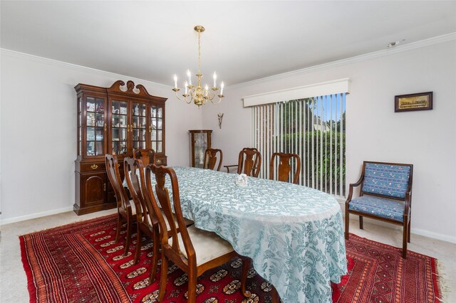 dining space featuring ornamental molding, a notable chandelier, and carpet flooring