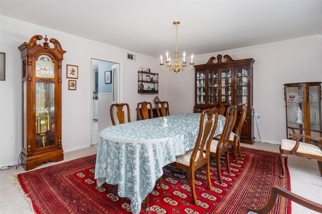 carpeted dining area featuring a chandelier and crown molding