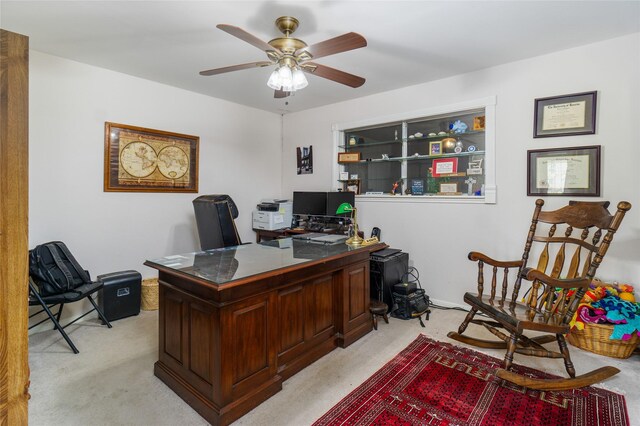 carpeted home office with ceiling fan