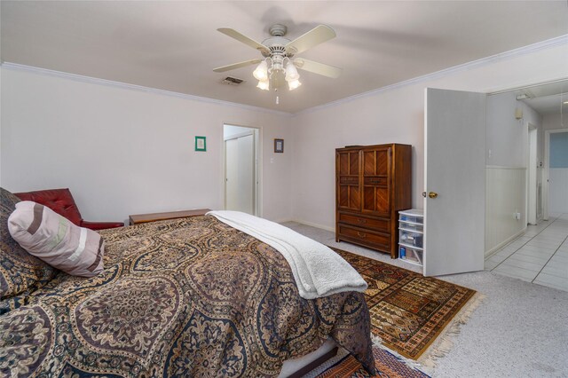 carpeted bedroom featuring ornamental molding and ceiling fan