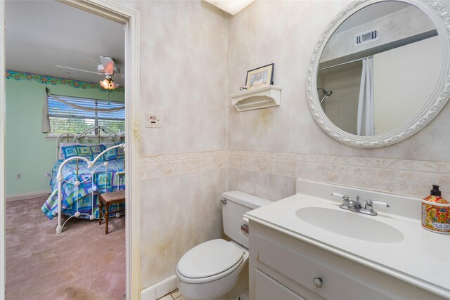 bathroom featuring vanity, toilet, and walk in shower