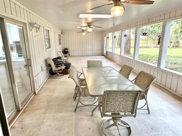 sunroom featuring ceiling fan