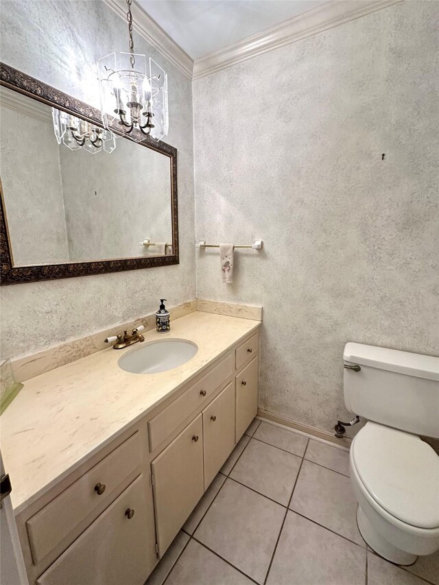 bathroom with ornamental molding, vanity, toilet, and tile patterned flooring