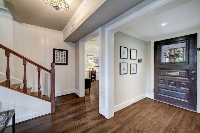 foyer with dark hardwood / wood-style floors and crown molding