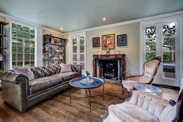 living room with french doors, ornamental molding, hardwood / wood-style floors, and a wealth of natural light