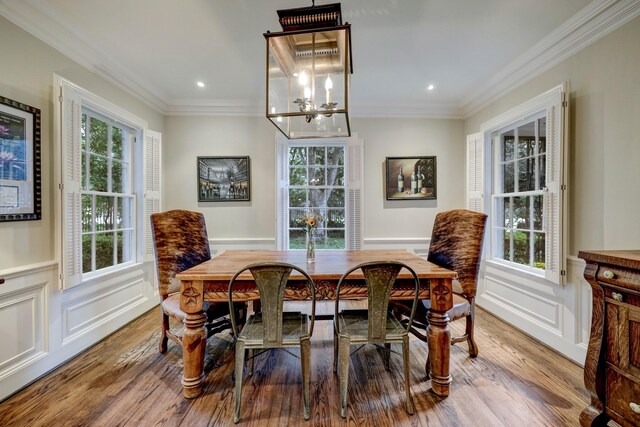 dining space featuring ornamental molding, plenty of natural light, and hardwood / wood-style floors