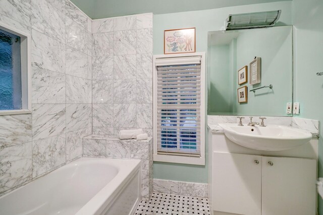 bathroom featuring tile walls, a washtub, and vanity