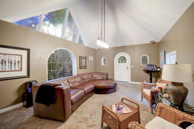 living room with high vaulted ceiling