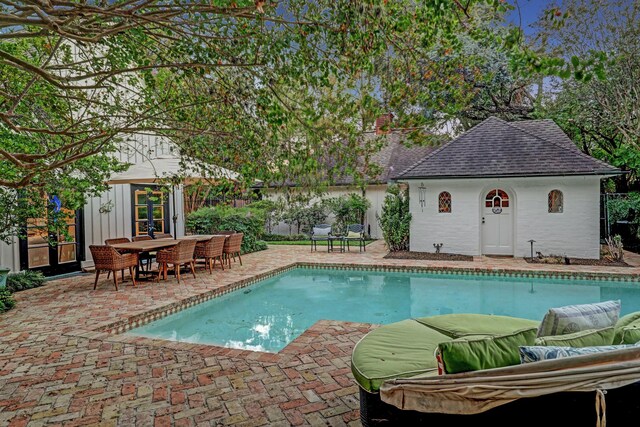 view of pool featuring a patio and an outbuilding