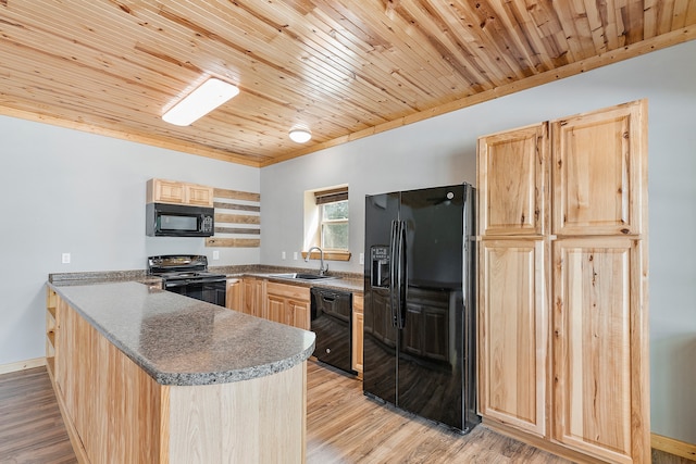 kitchen featuring light wood-type flooring, black appliances, light brown cabinets, and sink