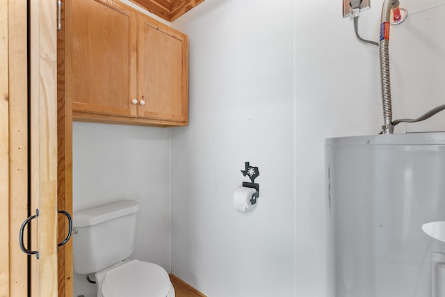 bathroom featuring gas water heater and toilet