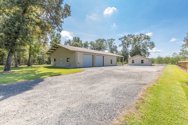 ranch-style house with an outbuilding, a garage, and a front yard