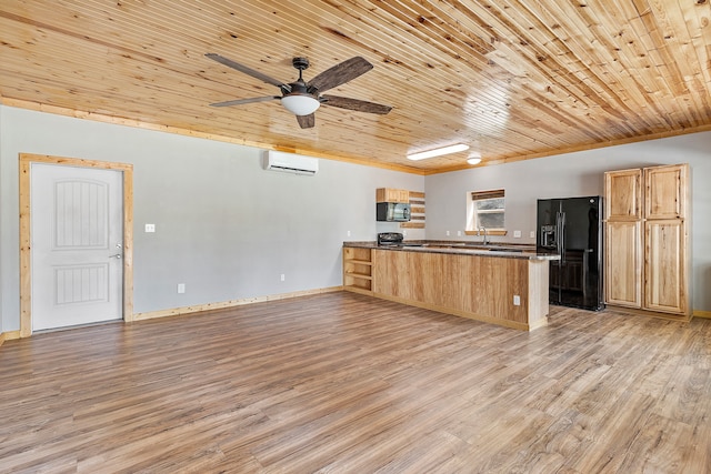 kitchen featuring black appliances, kitchen peninsula, light wood-type flooring, and ceiling fan