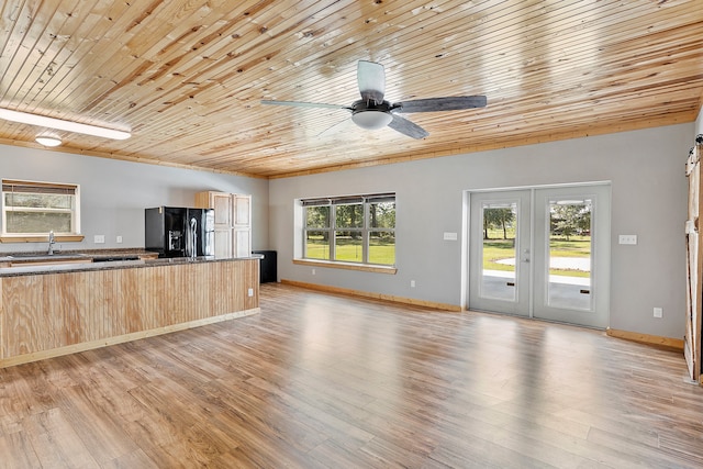 unfurnished living room with light hardwood / wood-style flooring, ceiling fan, and wooden ceiling