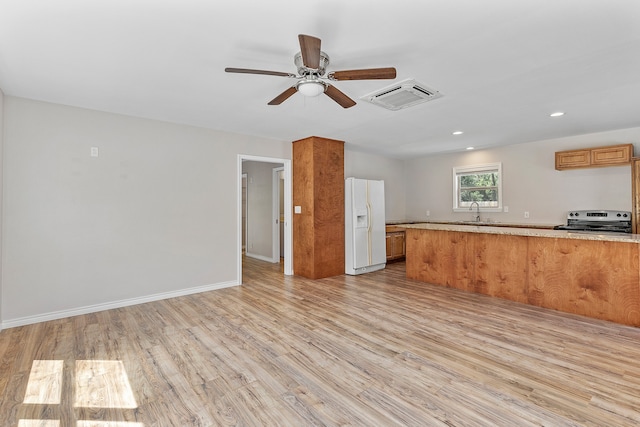 interior space with light wood-type flooring, electric range, white refrigerator with ice dispenser, kitchen peninsula, and ceiling fan