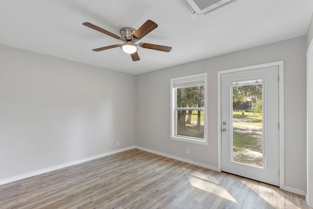 empty room with light hardwood / wood-style flooring and ceiling fan