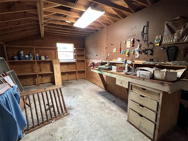 miscellaneous room featuring vaulted ceiling and a workshop area