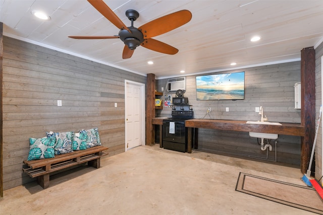 bar featuring black electric range, ceiling fan, wooden walls, and sink