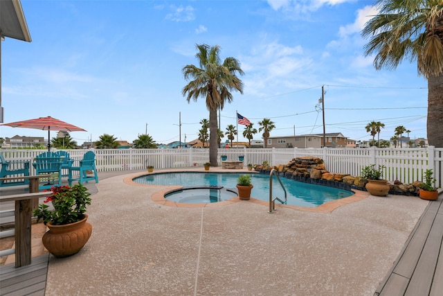 view of pool with a patio area and an in ground hot tub