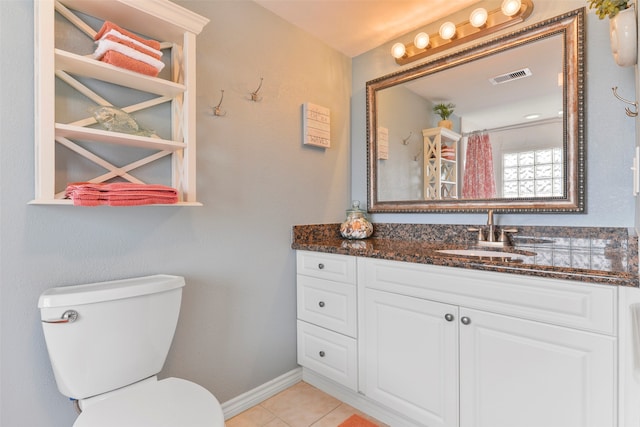 bathroom featuring vanity, toilet, and tile patterned floors