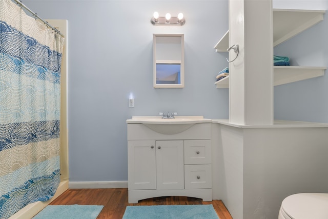 bathroom with vanity, a shower with curtain, toilet, and hardwood / wood-style flooring