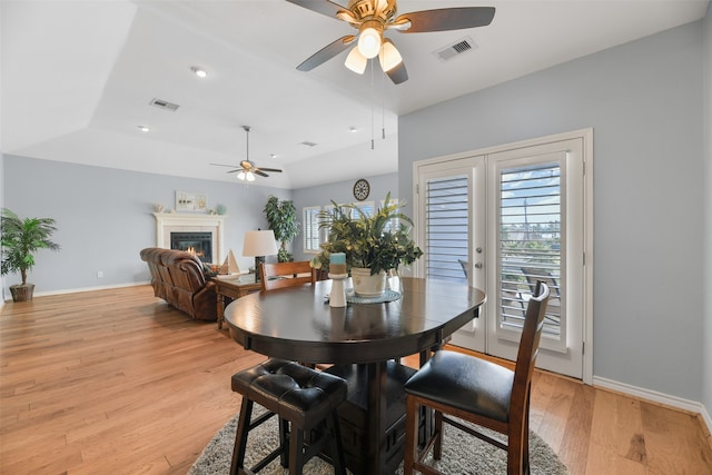 dining area with ceiling fan and light hardwood / wood-style floors