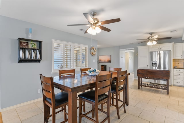 tiled dining space featuring ceiling fan