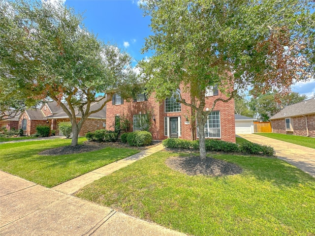 view of front of home with a garage and a front lawn