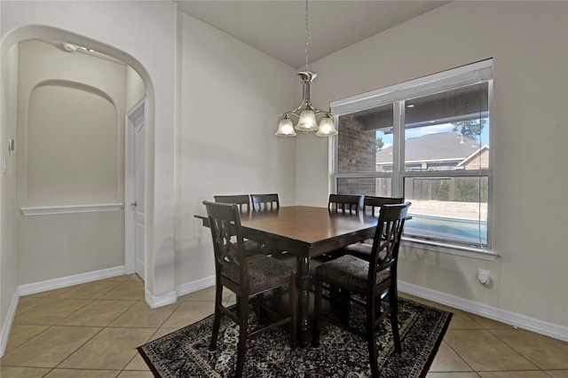 tiled dining area with a notable chandelier