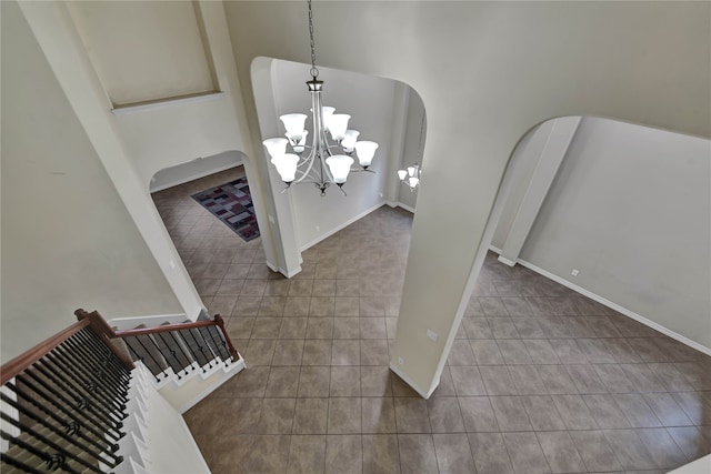 unfurnished dining area featuring an inviting chandelier and tile patterned flooring