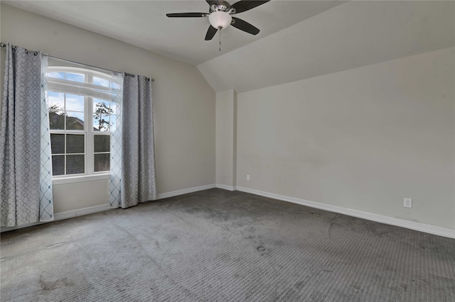 unfurnished room with ceiling fan, lofted ceiling, and carpet flooring