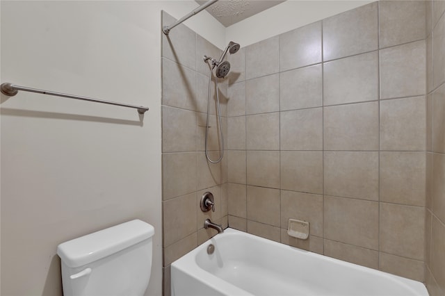 bathroom featuring tiled shower / bath and toilet