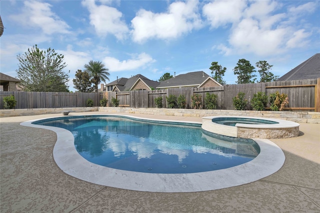 view of pool featuring an in ground hot tub