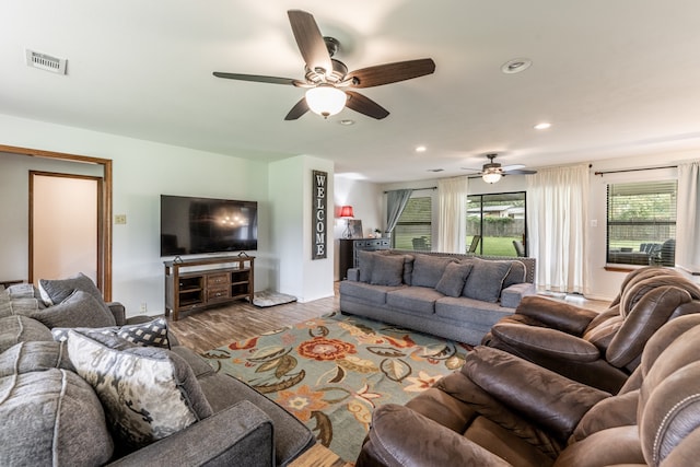 living room featuring ceiling fan and wood-type flooring