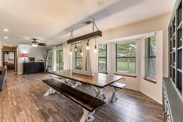 dining space with ceiling fan and dark hardwood / wood-style flooring